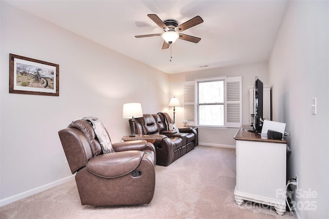 living area featuring baseboards, ceiling fan, visible vents, and light colored carpet