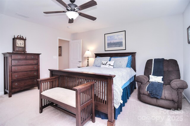 bedroom featuring light carpet, visible vents, and a ceiling fan