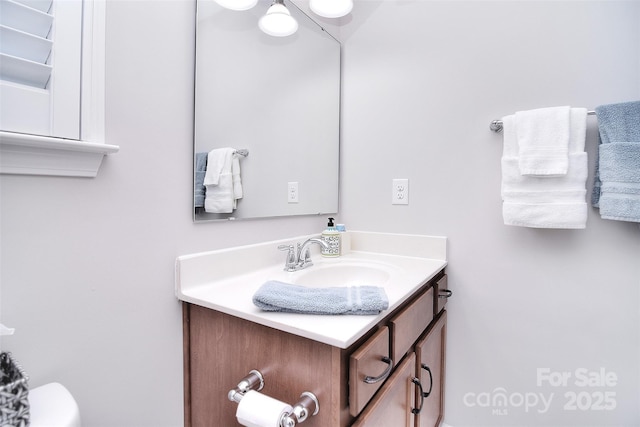 bathroom with toilet and vanity