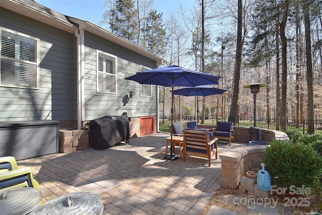 view of patio featuring an outdoor hangout area, fence, and grilling area