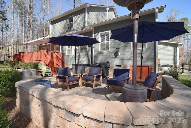 view of patio with fence and a wooden deck