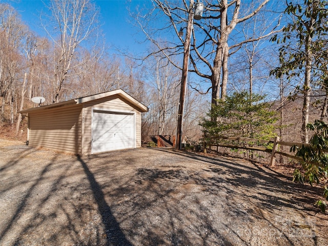 detached garage featuring aphalt driveway