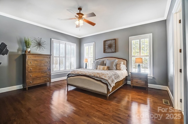 bedroom with crown molding, wood finished floors, visible vents, and baseboards