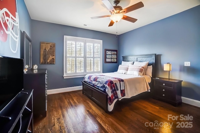 bedroom featuring visible vents, ceiling fan, baseboards, and wood finished floors