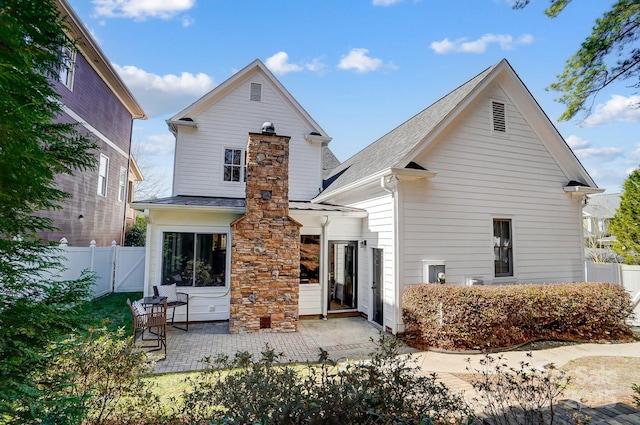 rear view of property with a patio area and fence