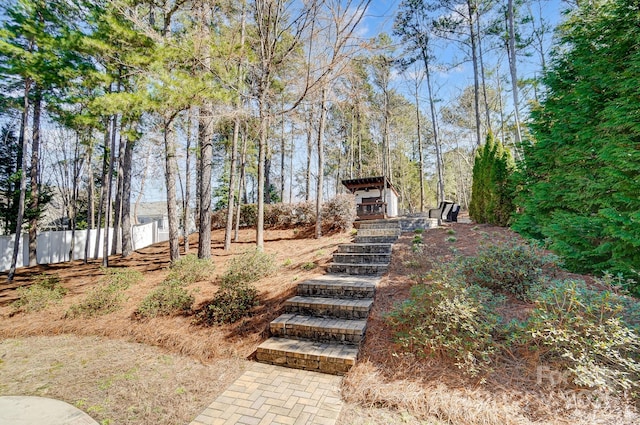 view of yard featuring stairs and fence