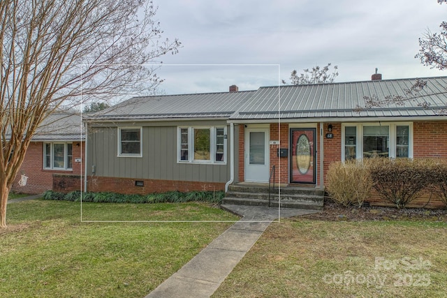 ranch-style house featuring entry steps, a chimney, metal roof, crawl space, and a front lawn