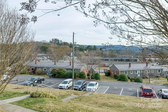 uncovered parking lot featuring a residential view