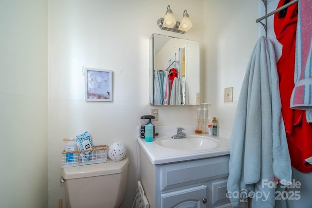 bathroom with toilet and vanity