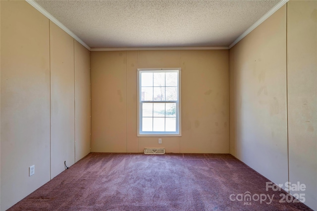 carpeted empty room with a textured ceiling, visible vents, and crown molding