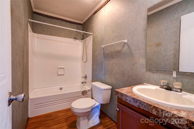 bathroom featuring shower / bathtub combination, toilet, wood finished floors, vanity, and ornamental molding