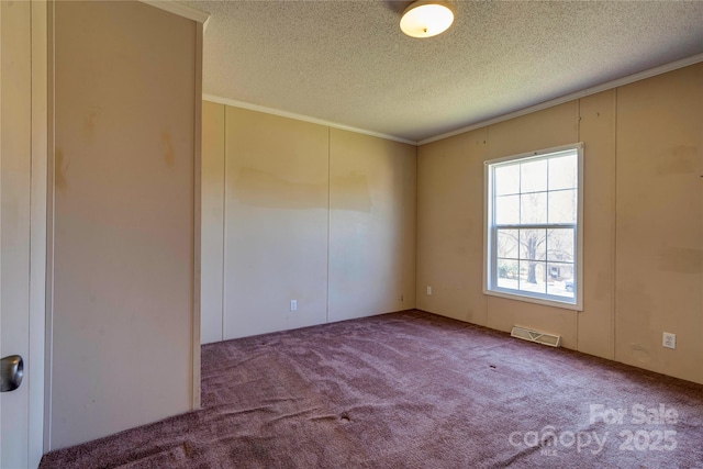 unfurnished room featuring carpet, visible vents, and a textured ceiling