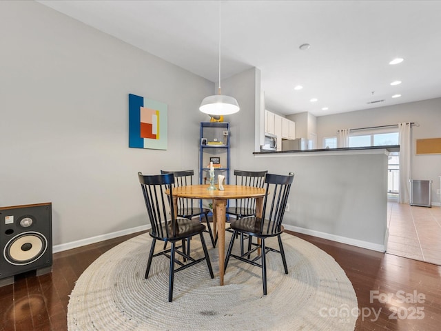 dining room featuring recessed lighting, baseboards, and wood finished floors