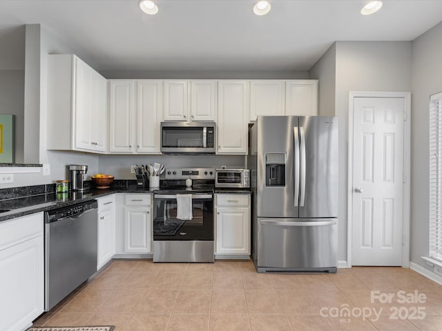 kitchen with light tile patterned floors, appliances with stainless steel finishes, white cabinetry, and recessed lighting