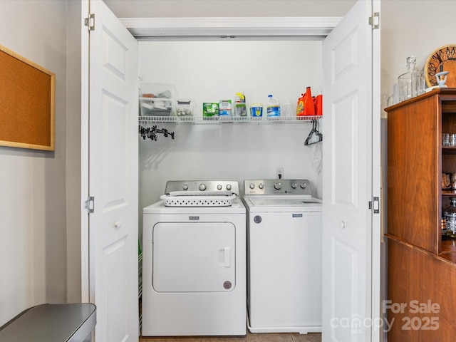 clothes washing area with laundry area and washer and clothes dryer