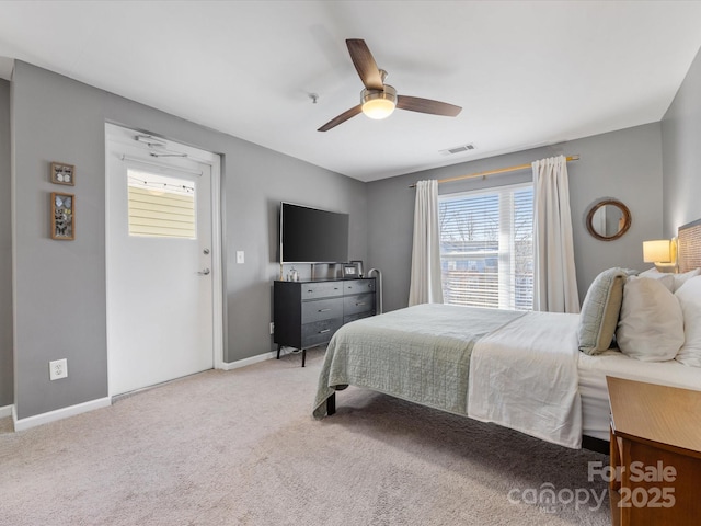 bedroom with a ceiling fan, carpet flooring, visible vents, and baseboards