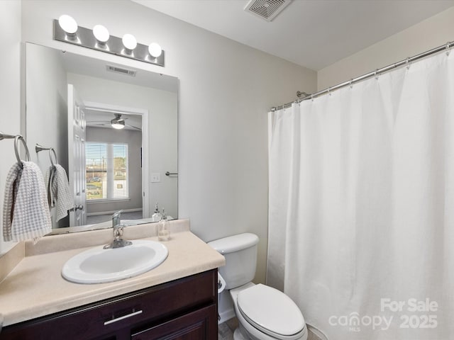 full bath with visible vents, vanity, and toilet