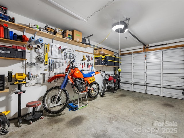 garage with a workshop area and a garage door opener