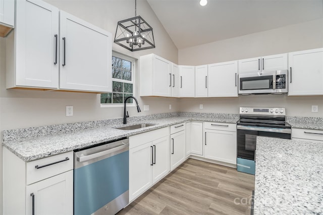 kitchen featuring appliances with stainless steel finishes, light wood-style flooring, and white cabinets