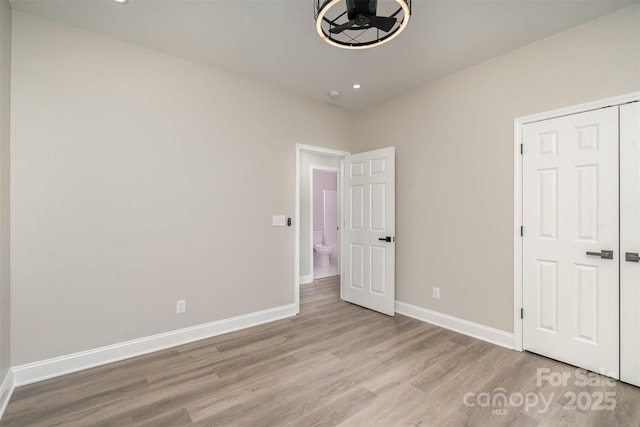 unfurnished bedroom with light wood finished floors, baseboards, and recessed lighting