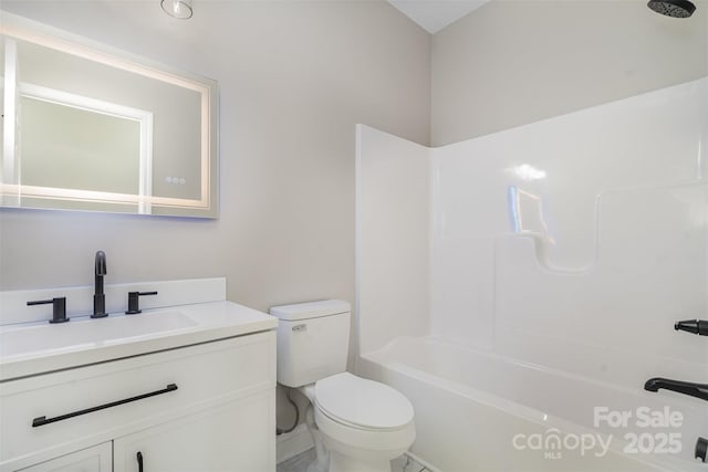 full bathroom featuring  shower combination, vanity, and toilet