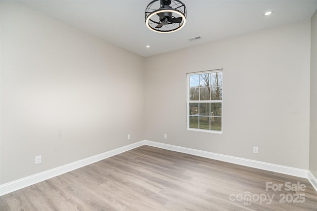 spare room featuring recessed lighting, visible vents, baseboards, and wood finished floors