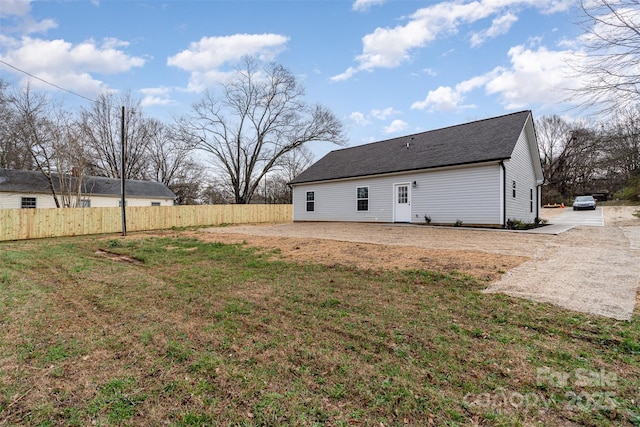 back of house with a yard, a patio area, and fence