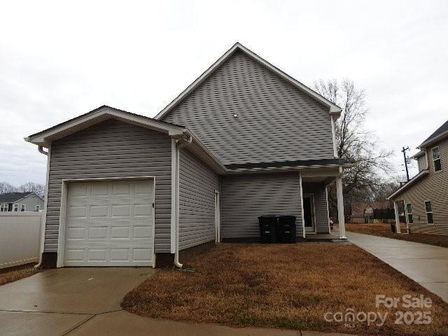 view of home's exterior featuring concrete driveway and an attached garage