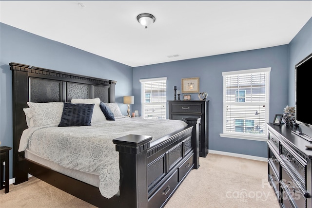 bedroom featuring light colored carpet, visible vents, and baseboards