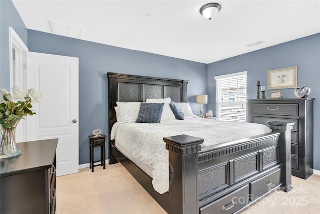 bedroom featuring light carpet, baseboards, and visible vents