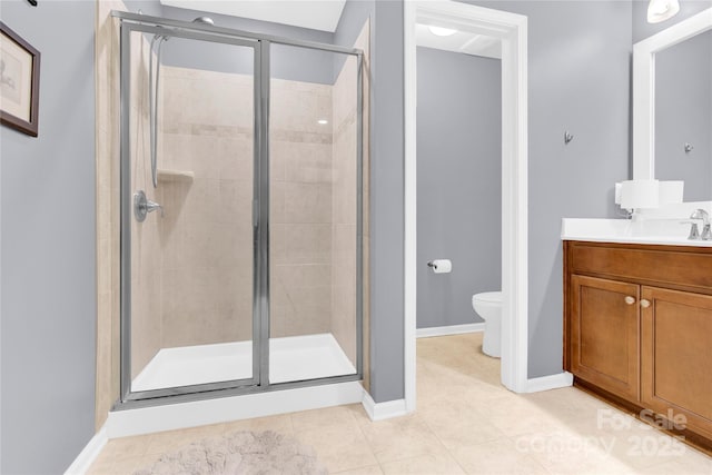 full bath featuring toilet, a shower stall, vanity, tile patterned flooring, and baseboards