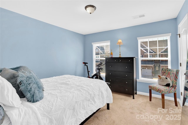 bedroom featuring visible vents, light colored carpet, and baseboards