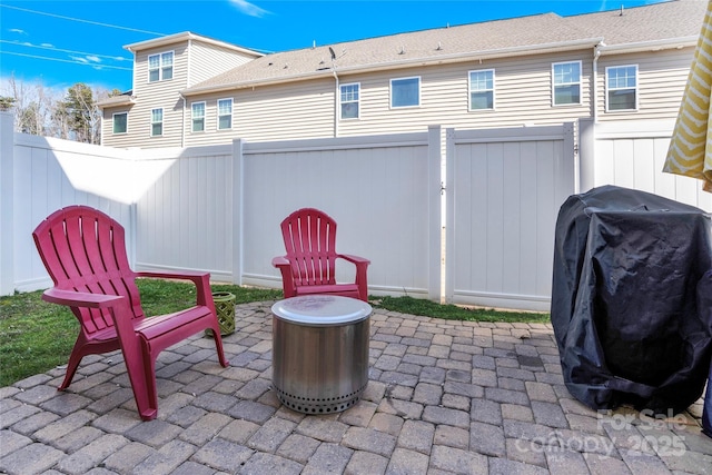 view of patio with grilling area and a fenced backyard