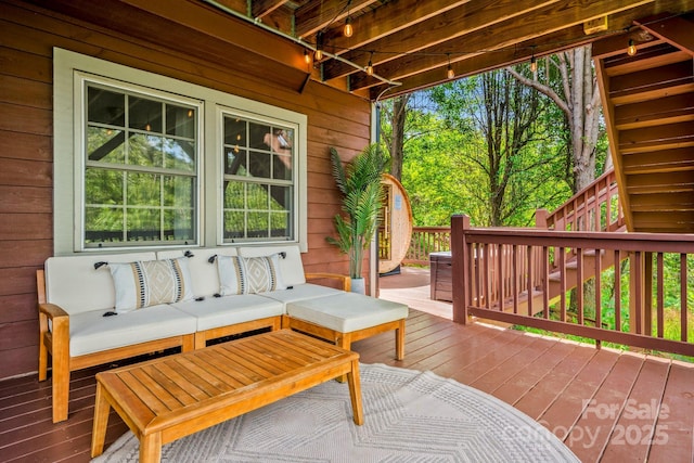 wooden terrace with stairs and an outdoor hangout area