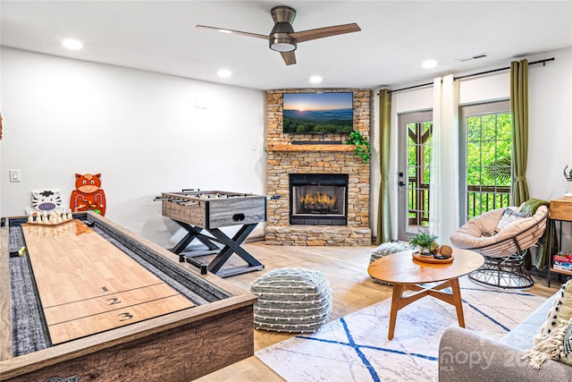 living room with a fireplace, visible vents, wood finished floors, and recessed lighting