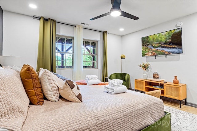 bedroom with a ceiling fan, visible vents, wood finished floors, and recessed lighting