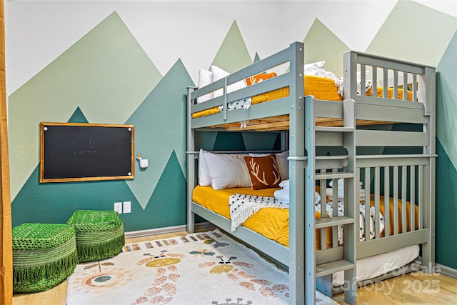 bedroom featuring baseboards and wood finished floors