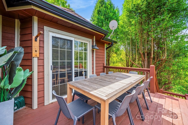 wooden terrace with outdoor dining area