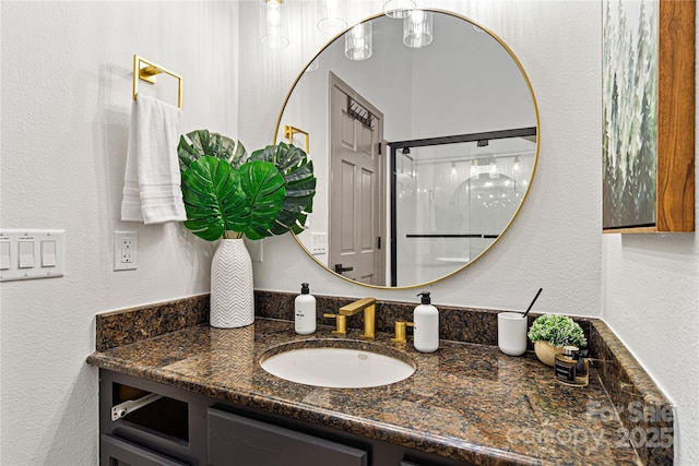 bathroom featuring a textured wall and vanity