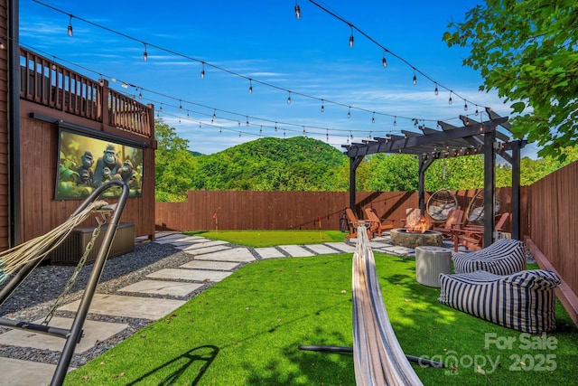 view of yard featuring an outdoor fire pit, a fenced backyard, and a pergola