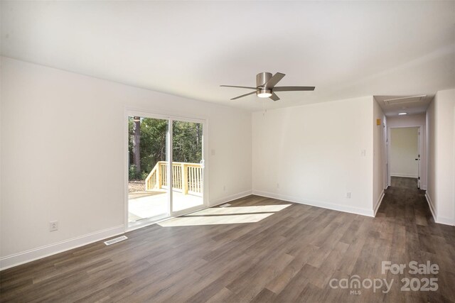 unfurnished room featuring dark wood-style flooring, a ceiling fan, and baseboards