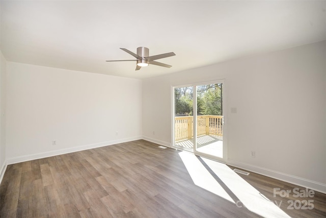 unfurnished room featuring visible vents, ceiling fan, baseboards, and wood finished floors