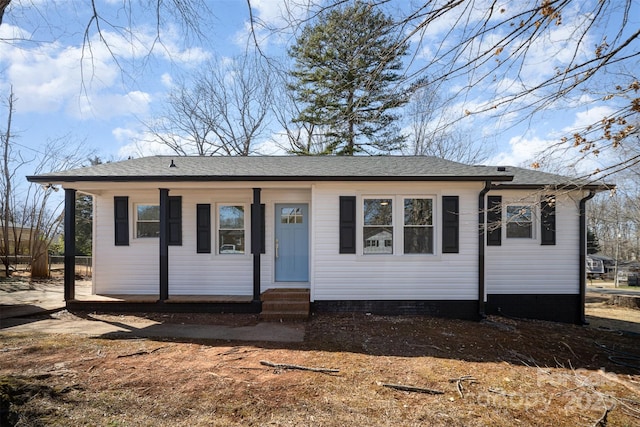 view of front of house featuring entry steps and roof with shingles