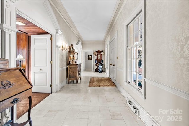 corridor featuring ornamental molding and visible vents