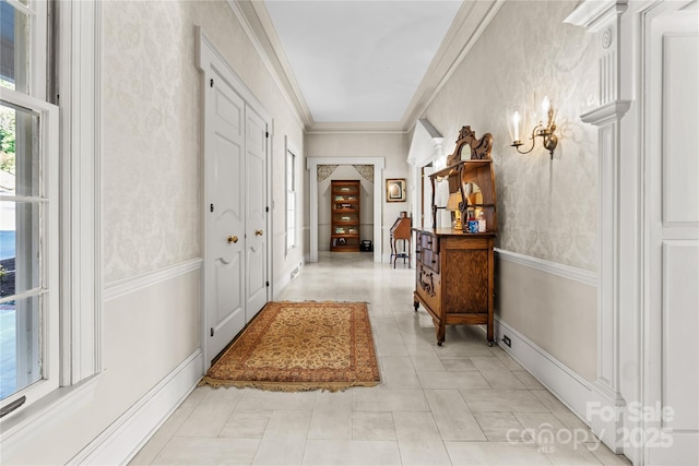 corridor featuring ornamental molding and light tile patterned floors