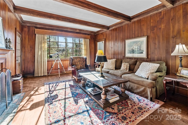 living area with hardwood / wood-style floors, beam ceiling, and wood walls