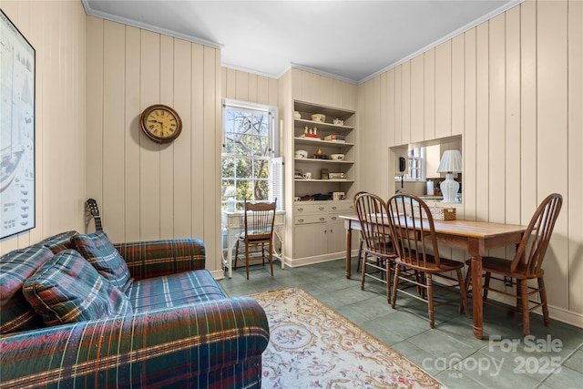 living area with wood walls, tile patterned flooring, built in features, and crown molding