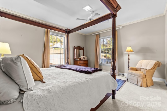 carpeted bedroom with a baseboard heating unit, ceiling fan, baseboards, and crown molding