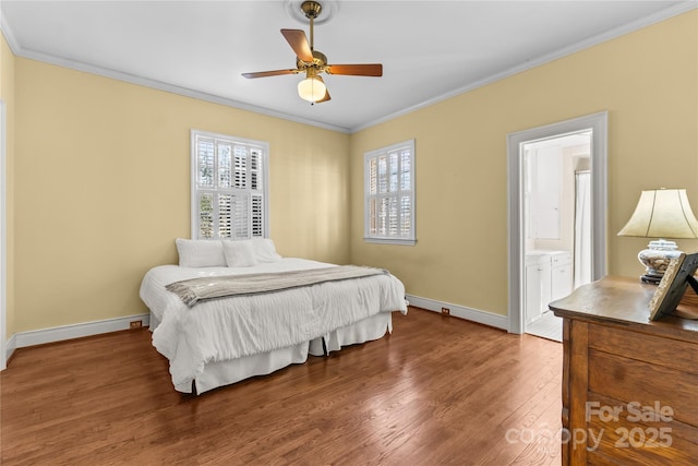 bedroom featuring baseboards, multiple windows, wood finished floors, and crown molding