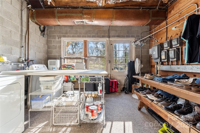 interior space featuring independent washer and dryer and concrete block wall